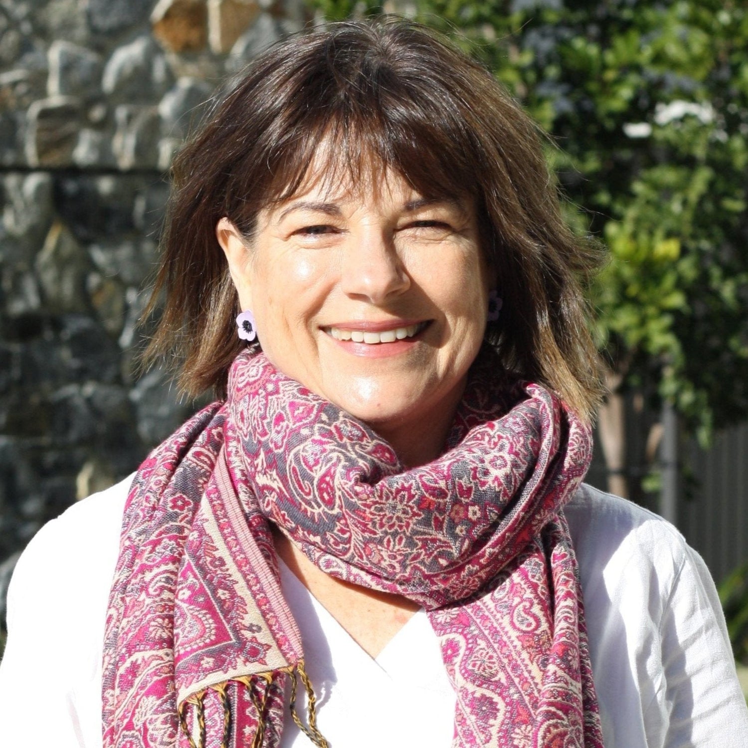This image shows me, Bron the owner of The Pretty Scarf Co. I am wearing a pink pashmina around my neck.