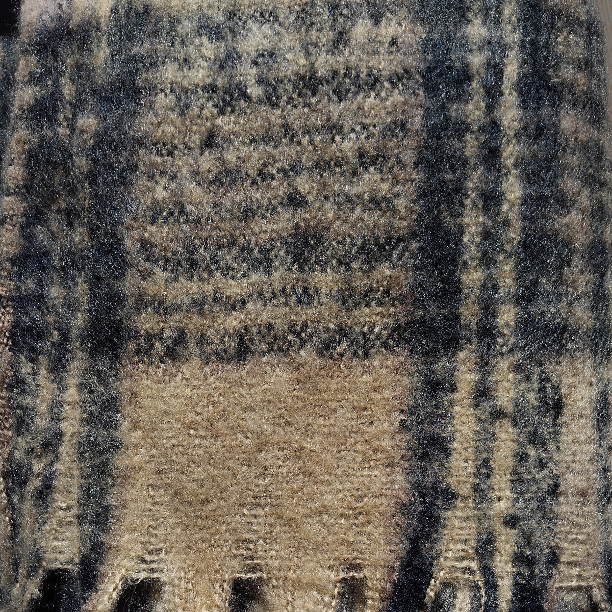 Close-up of a plaid scarf with black and tan brown colors