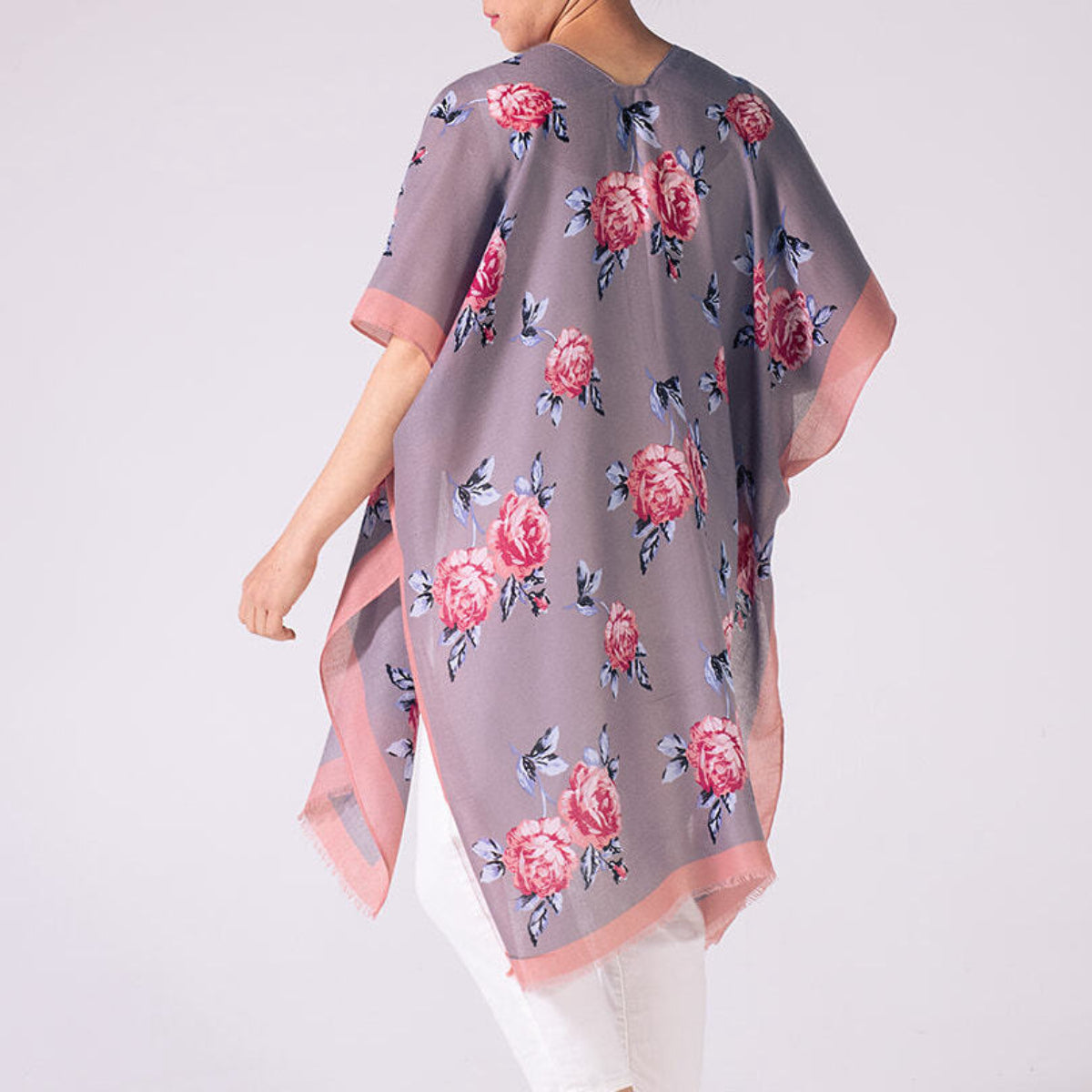 Person wearing a gray floral kimono-style garment on a white background