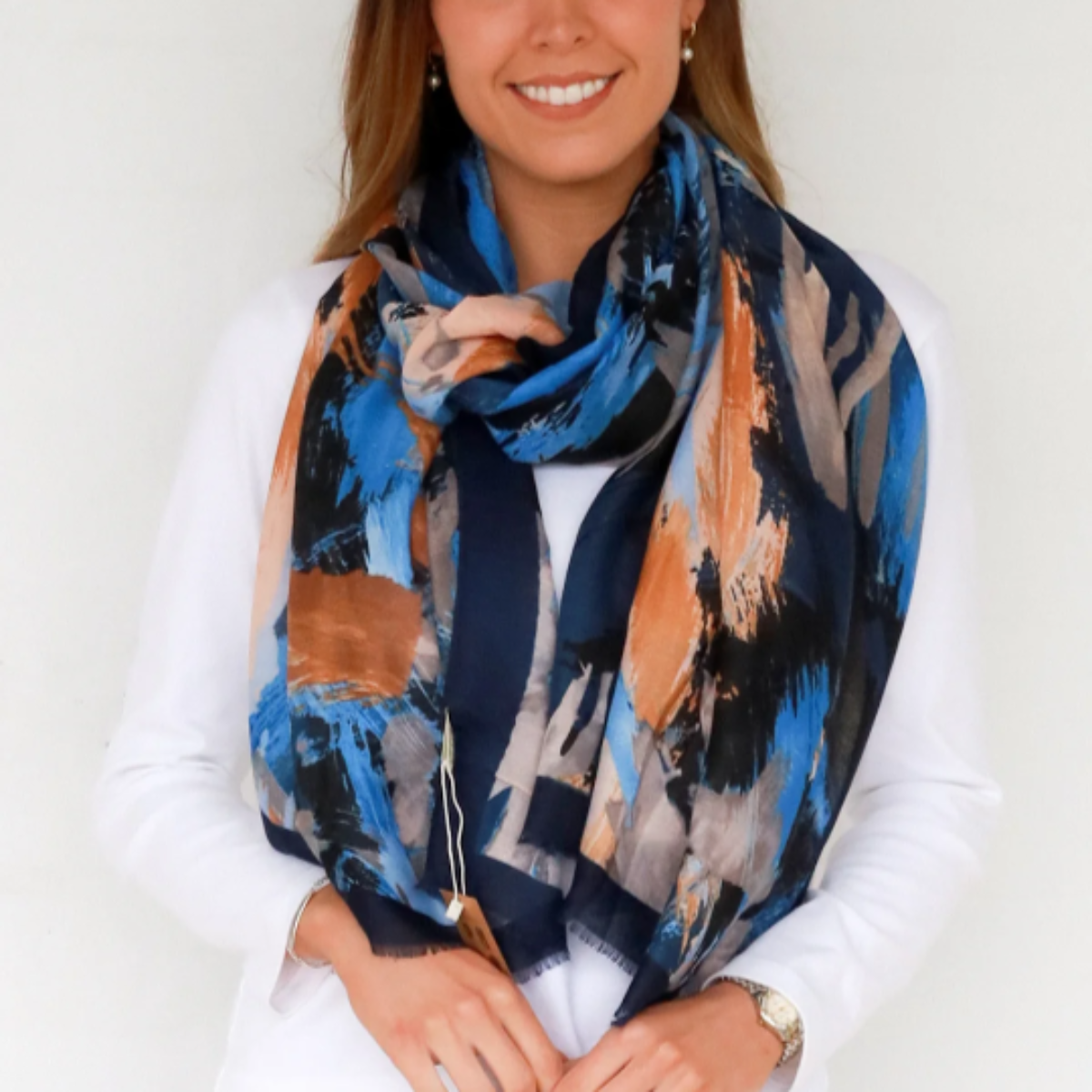 Woman wearing a colorful scarf against a white background