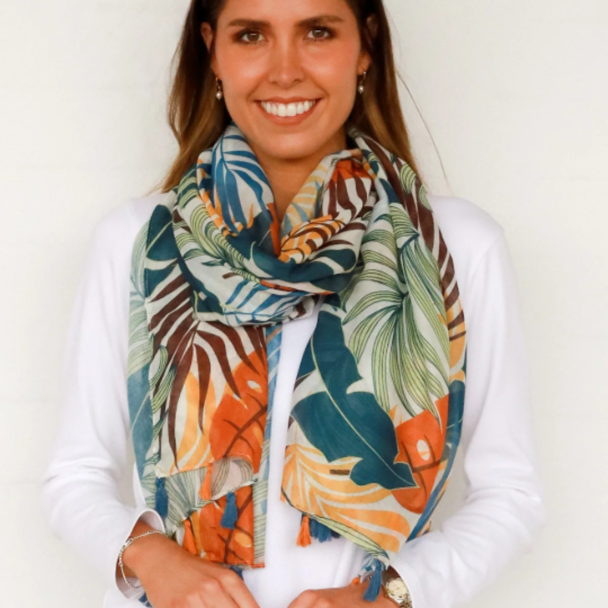 Woman wearing a colorful scarf with a white background