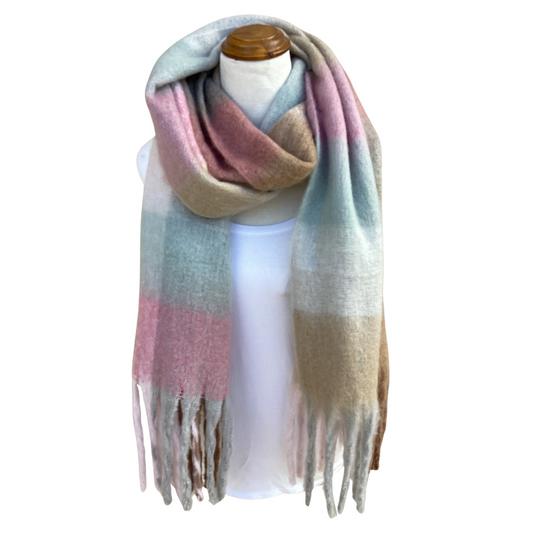 A soft, oversized plaid scarf in pastel shades of pink, beige, and light blue, draped on a white mannequin torso with a wooden neck cap against a plain white background.