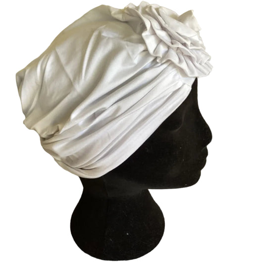 a head mannequin wearing a white turban