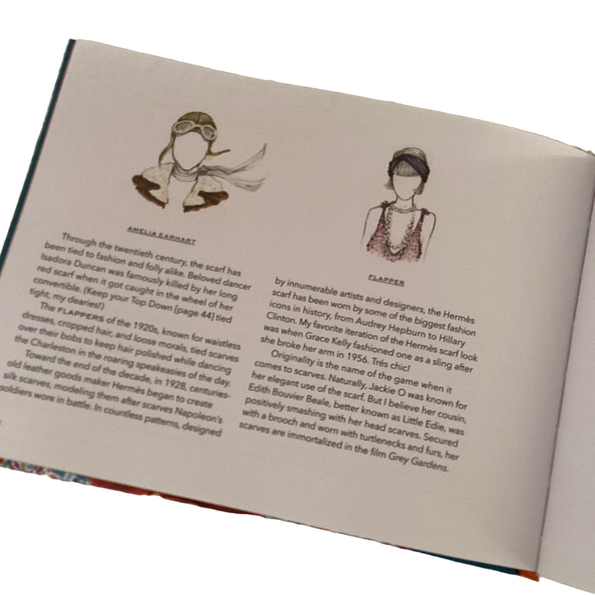 Open book with illustrations and text on a textured surface