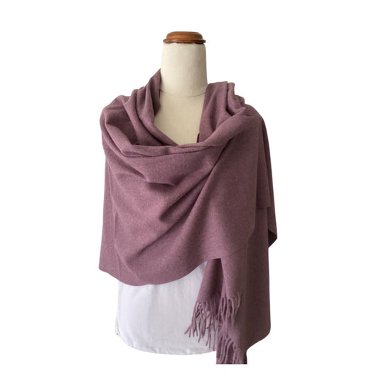 a plain muted purple winter scarf with tassels that has been draped over a mannequin. The scarf is very soft and warm and is finished with tassels.