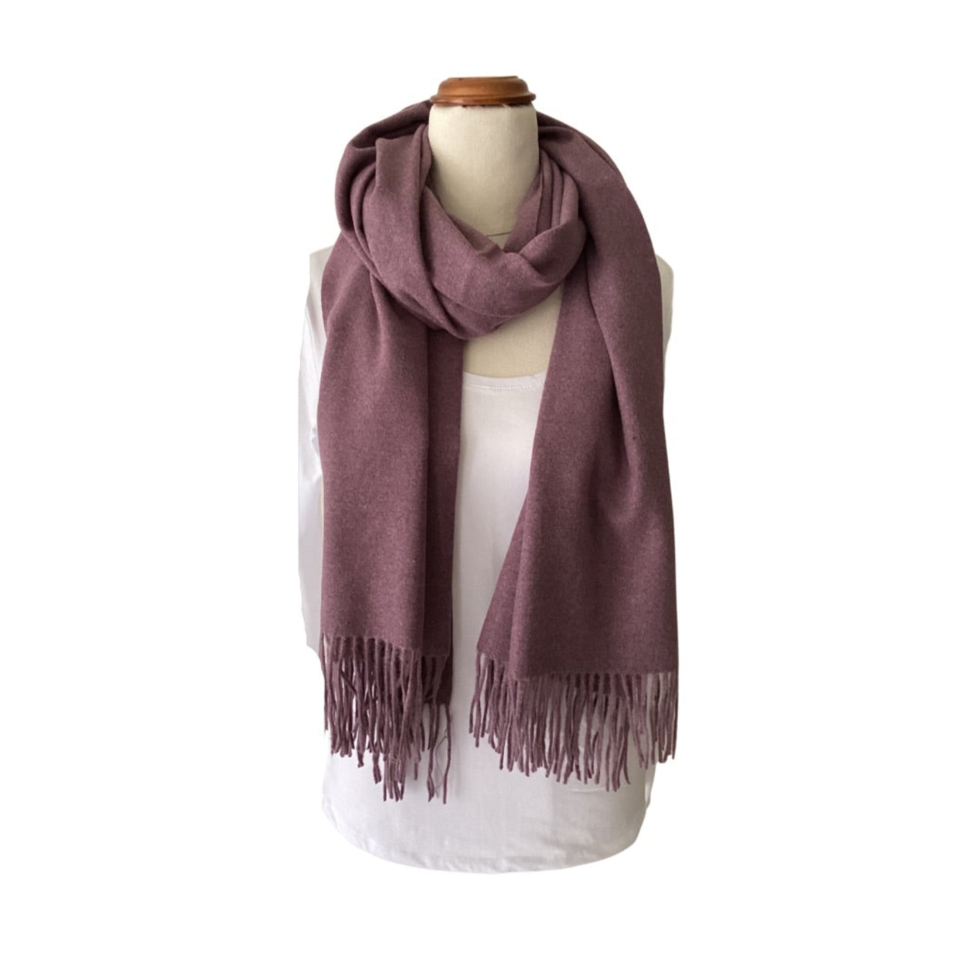 a plain winter scarf in a muted shade of purple with tassels