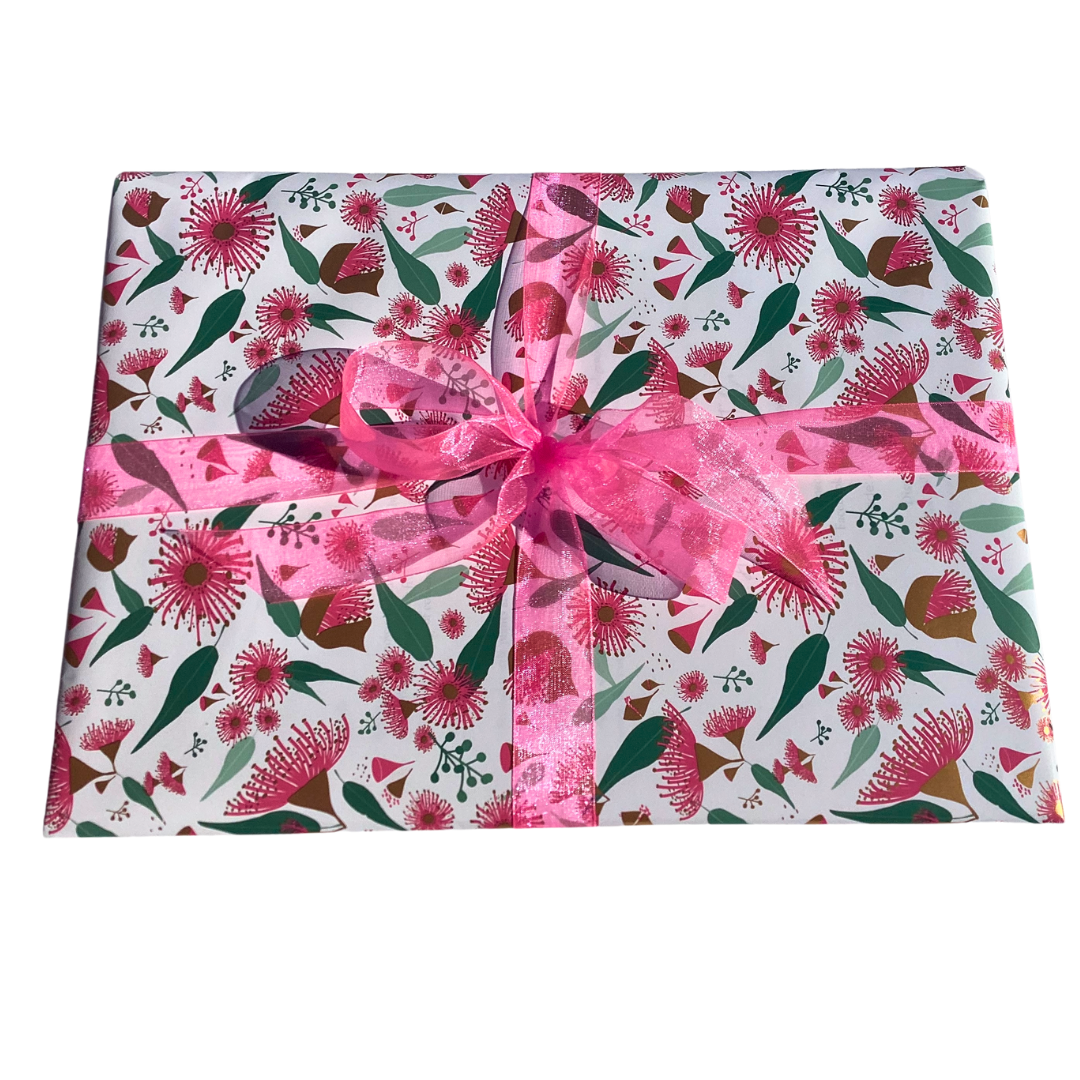 a ladies scarf wrapped in Eucalyptus blossom wrapping paper and tied with a bright pink ribbon