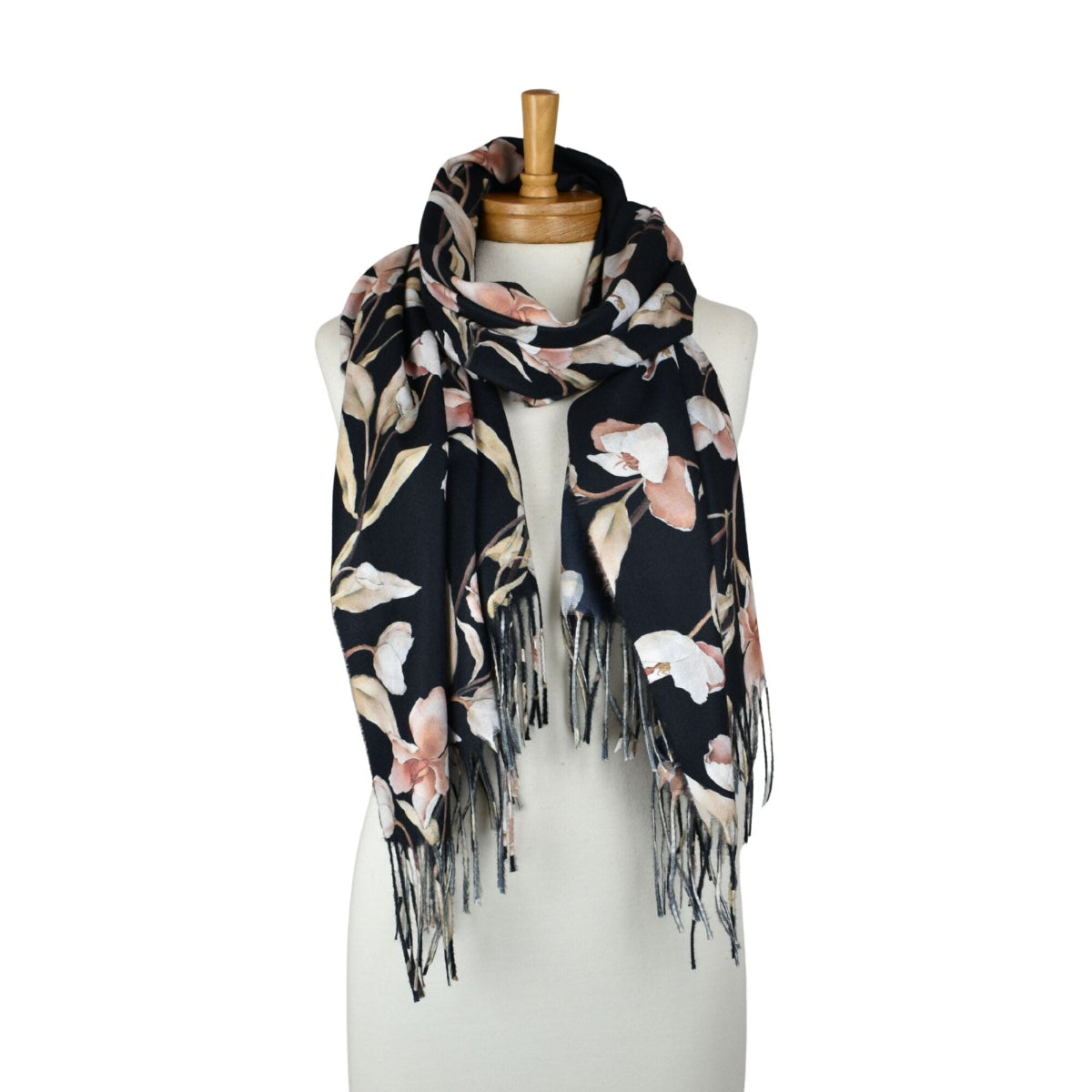 Floral patterned scarf with fringes on a mannequin against a white background