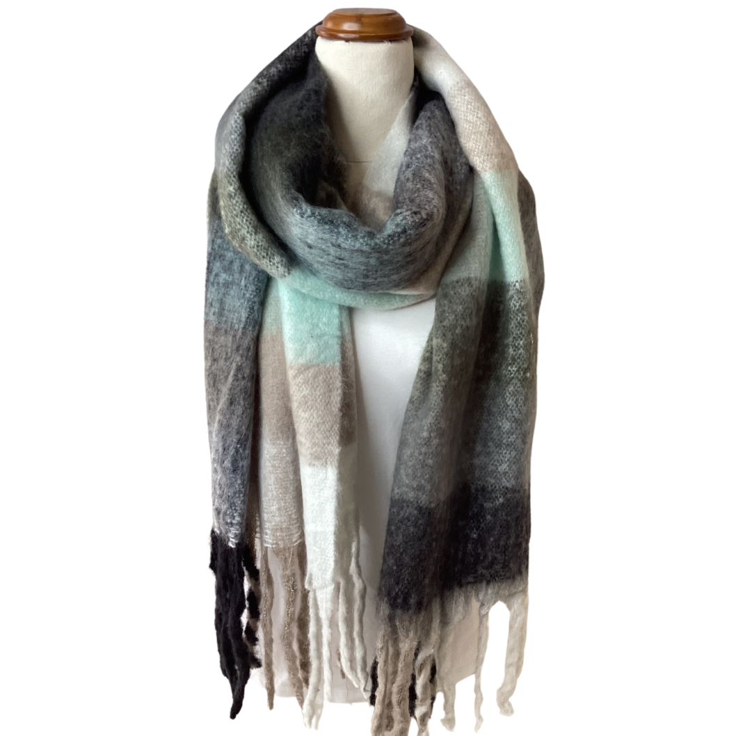 a large oversized blanket scarf that has large checks and chunky tassels