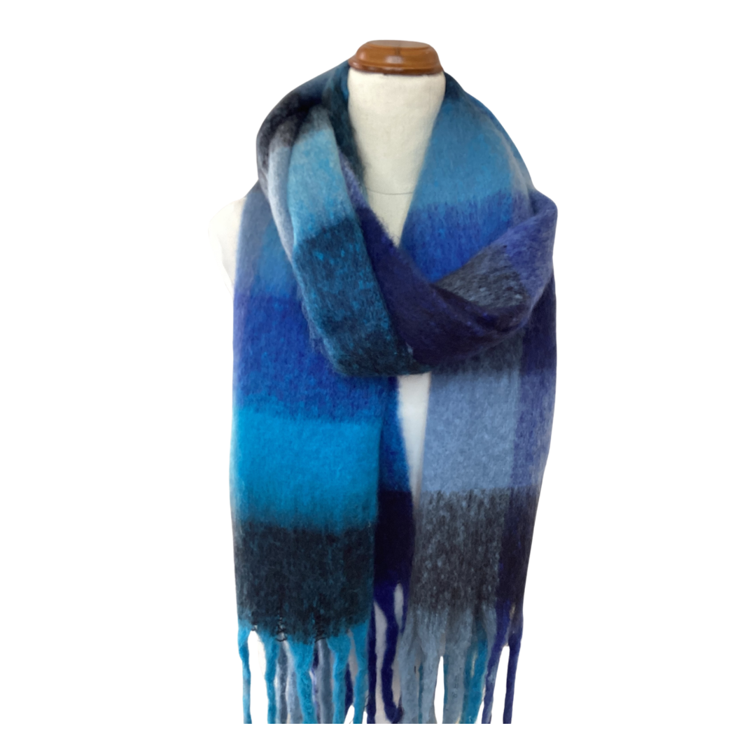 a large oversized blanket scarf with large blue checks and chunky tassels