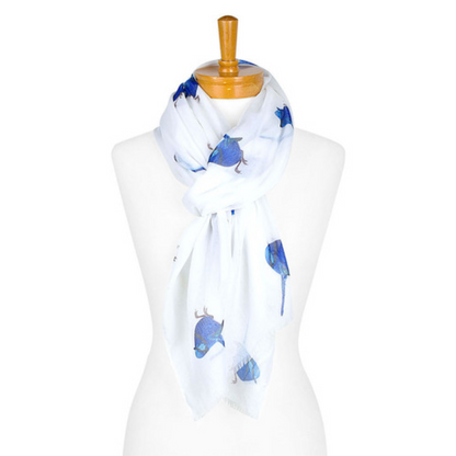 A cotton ladies scarf that has a white background and medium sized blue Splendid Fairy Wrens. The scarf is tied onto a mannequin.