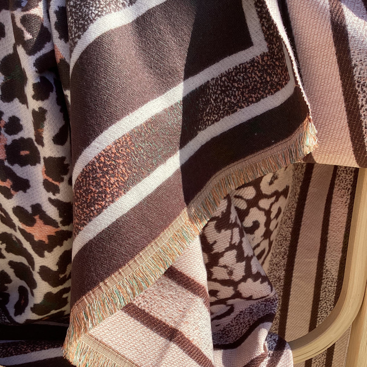 A leopard print scarf draped over a chair
