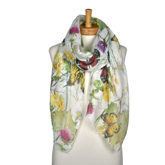 a ladies scarf that has a white background, large orange and red butterflies, green leaves and flowers in the shades of purple, pink and yellow.