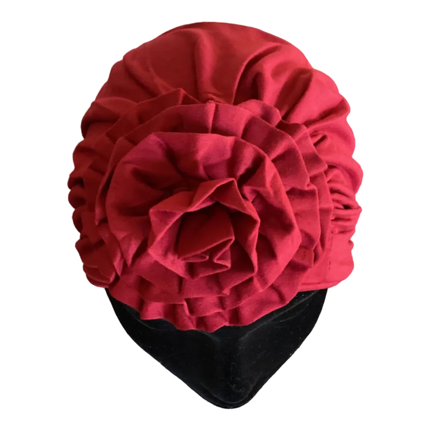 Close up of a red head turban that has a fabric flower