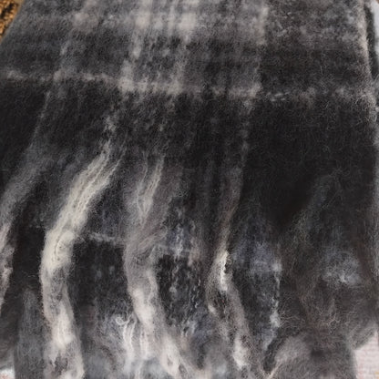 Close-up of a textured black and gray ladies scarf with a chunky fringe