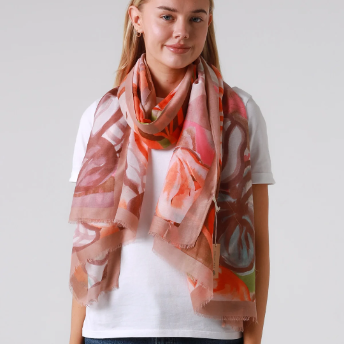 Woman wearing a floral scarf on a plain background