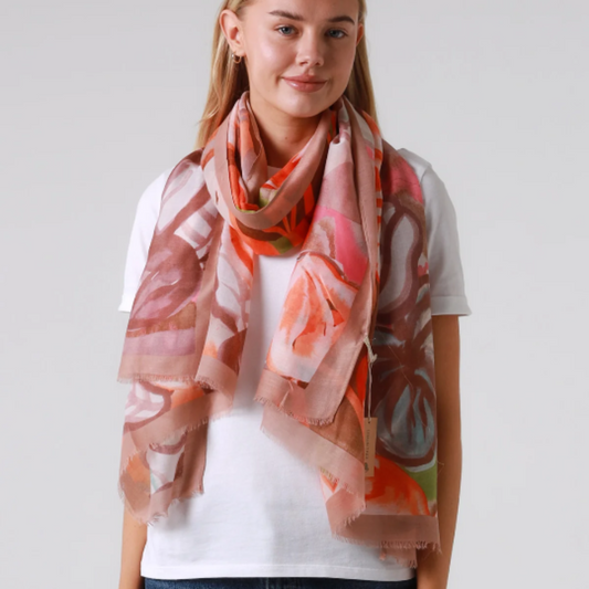 Woman wearing a floral scarf on a plain background