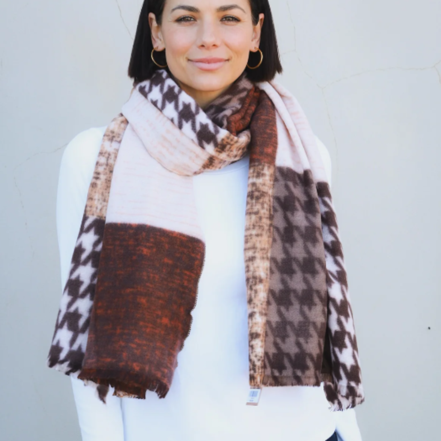 a brown and cream coloured thick scarf that has a patchwork pattern