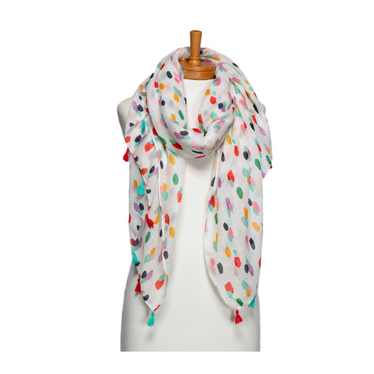 a pretty ladies scarf with bright coloured oblong dots on a white background and finished with alternating aqua and raspberry red tassels.