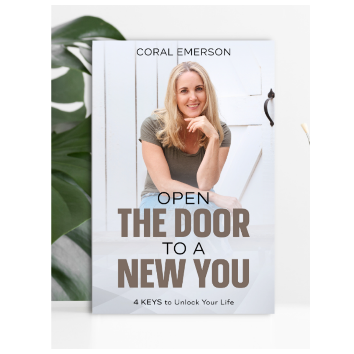 Book cover with a woman's portrait and text 'Open the Door to a New You' by Coral Emerson.