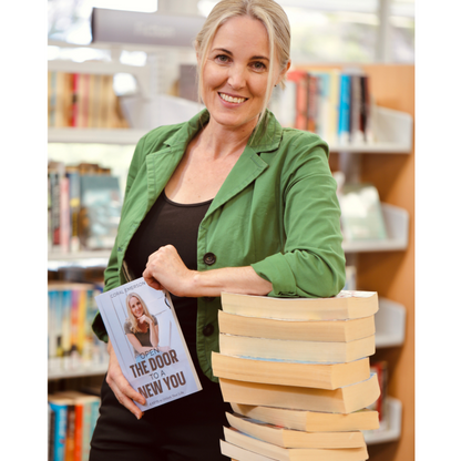 Photo of Coral Emerson holding a book Open The Door To A New You 