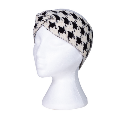Cream and black houndstooth knitted beanie on a mannequin head against a white background