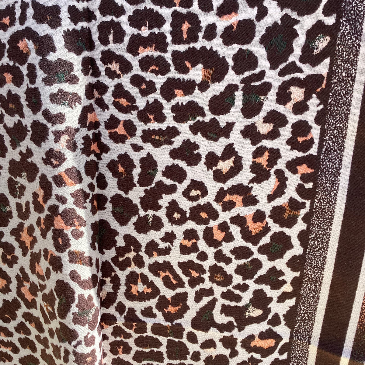 Leopard print fabric with a white border