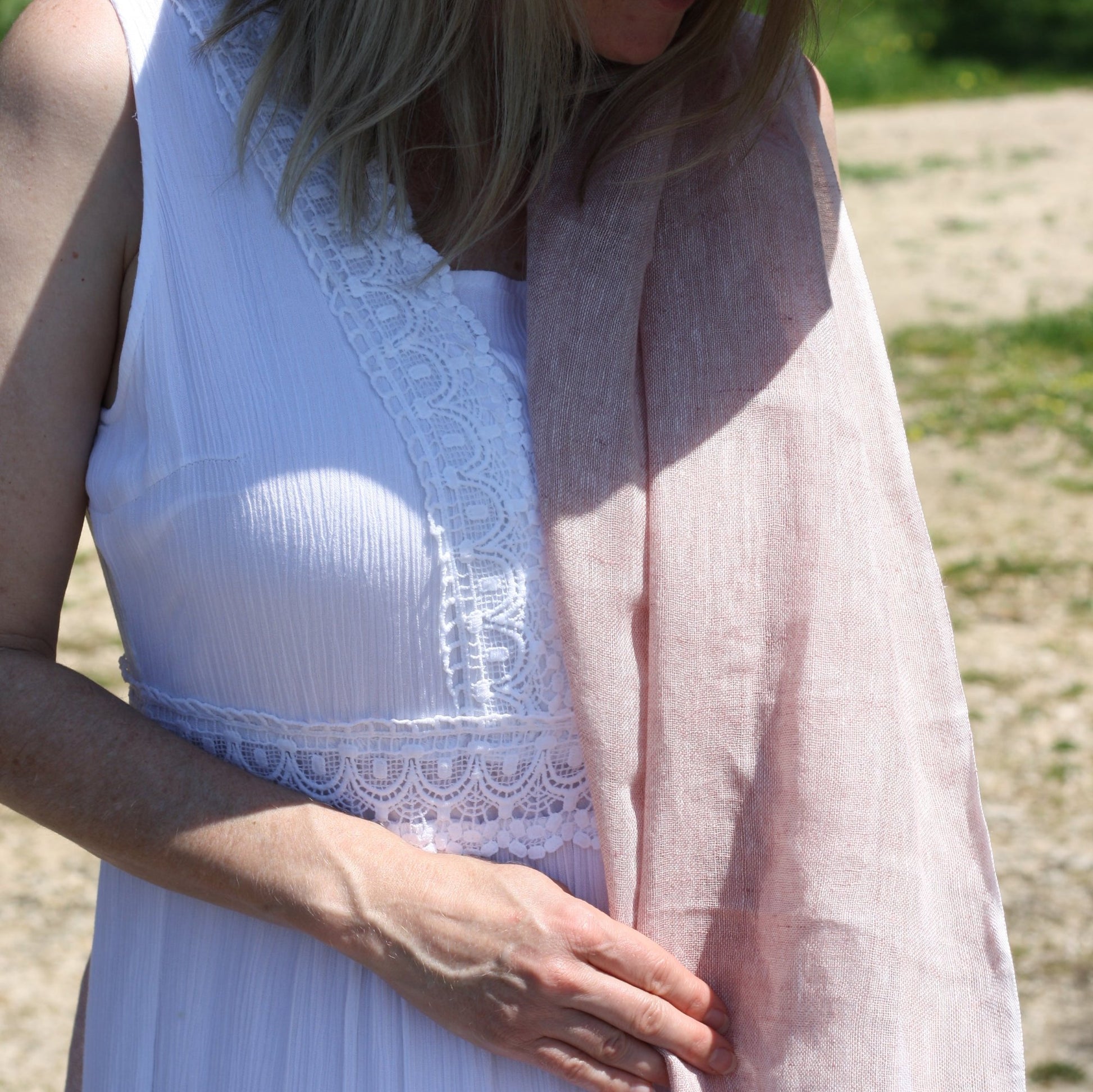 a lady wearing a dusty pink linen scarf