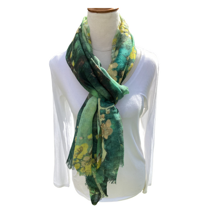 Green floral patterned scarf on a mannequin with a white background