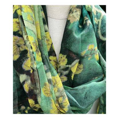 Green floral patterned scarf draped over a mannequin