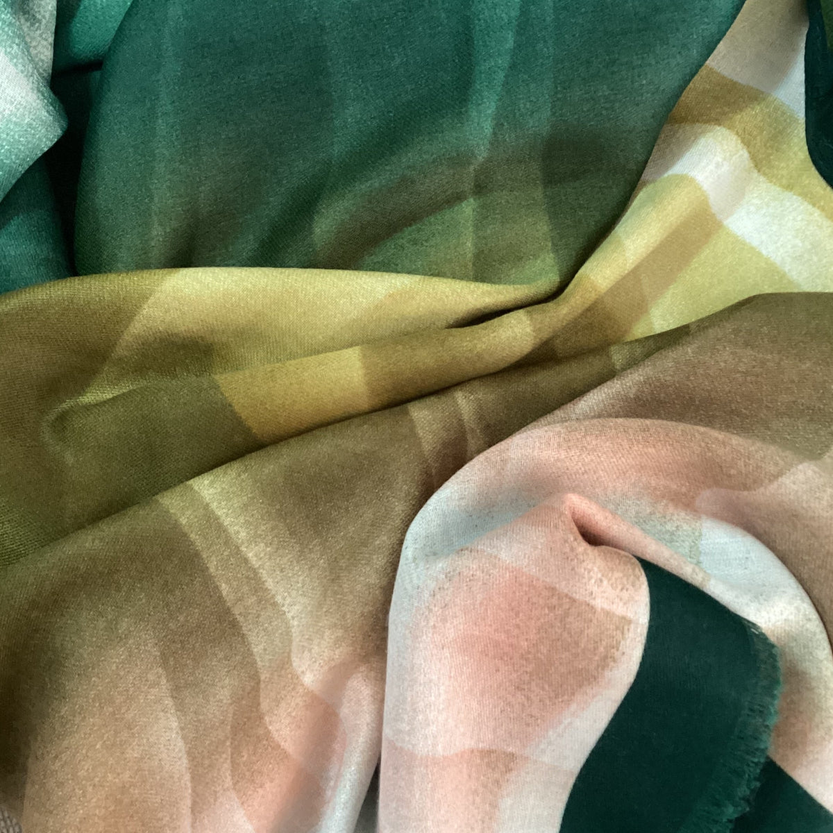 a close up photo of a ladies scarf that has a jewelled ombre pattern of green and salmon pink