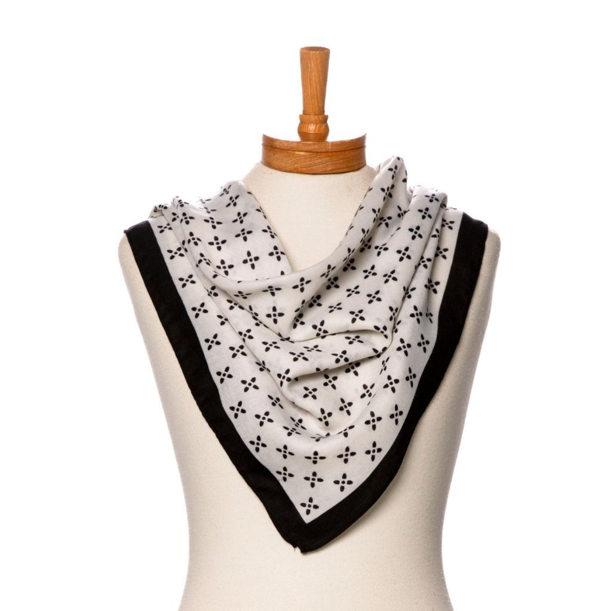 Black and white patterned scarf on a mannequin with a white background