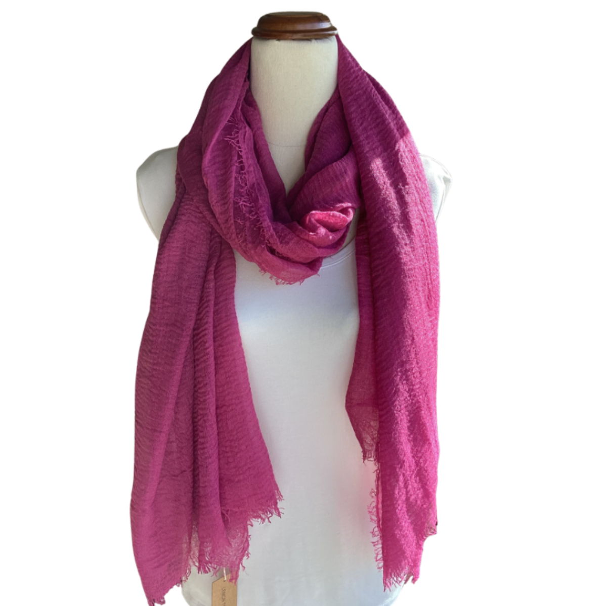 Mannequin wearing a bright pink scarf on a white background
