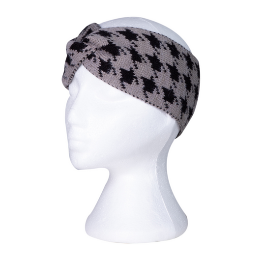 Grey knitted headband with a black houndstooth pattern on a mannequin head against a white background