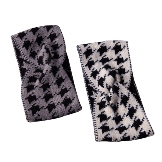 Two knitted headbands, one with a black and grey houndstooth pattern and the other a cream and black houndstooth pattern on a white background