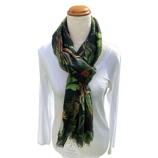 Mannequin wearing a white shirt with a green jungle patterned scarf.