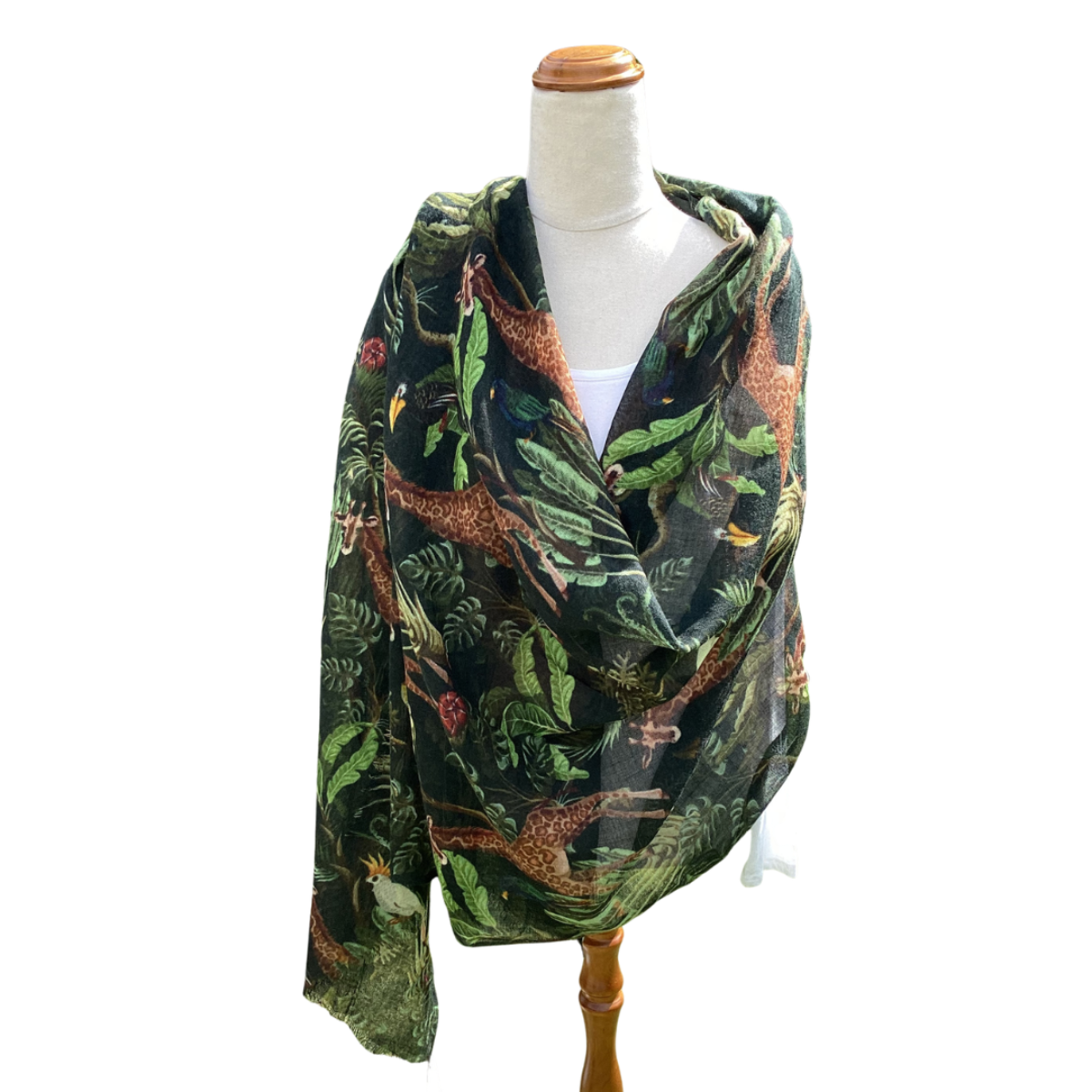 Scarf with nature-themed design on a mannequin against a white background