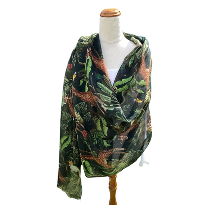 Scarf with nature-themed design on a mannequin against a white background