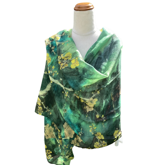Green floral patterned scarf on a mannequin with a white background