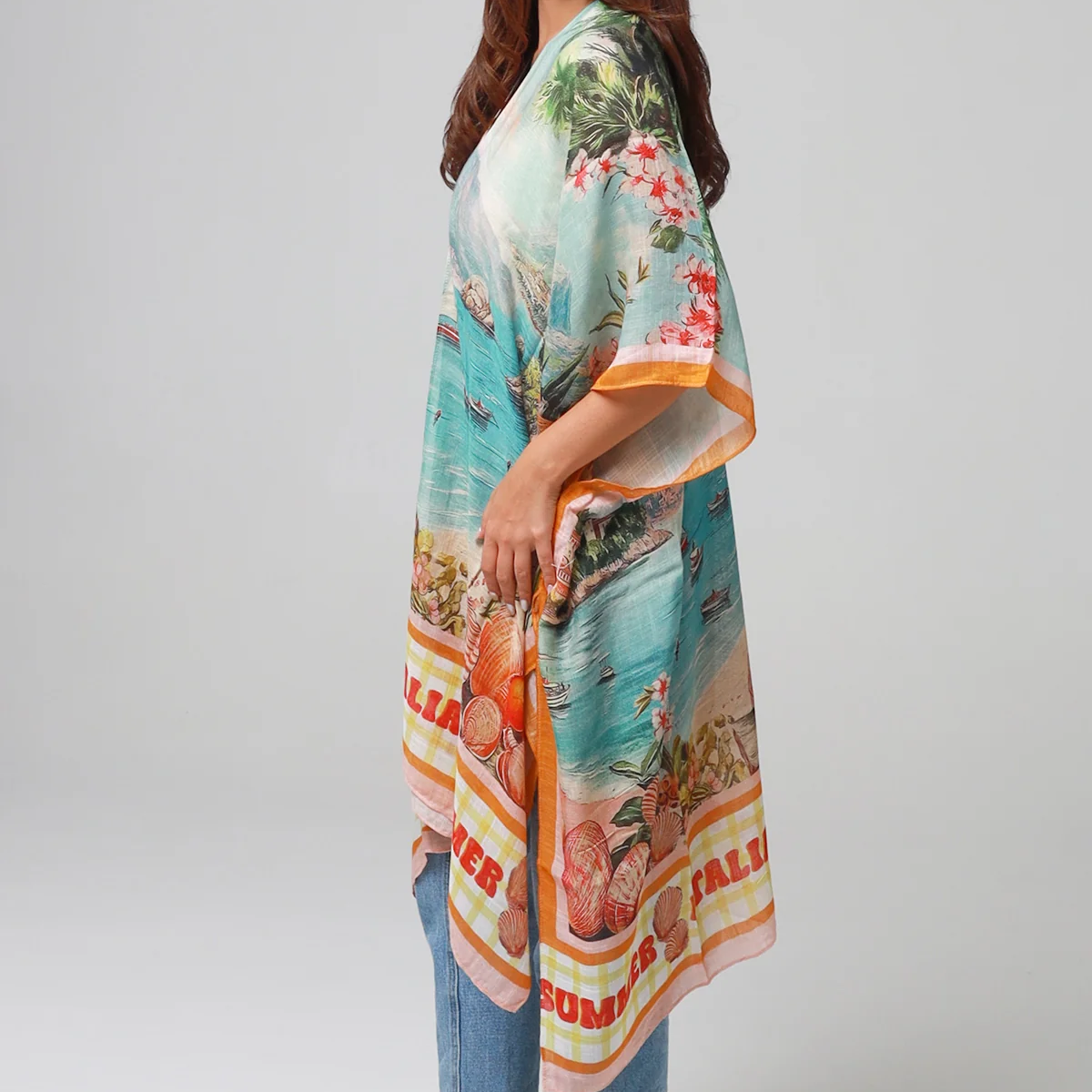 Woman wearing a colorful kimono-style garment with a white background
