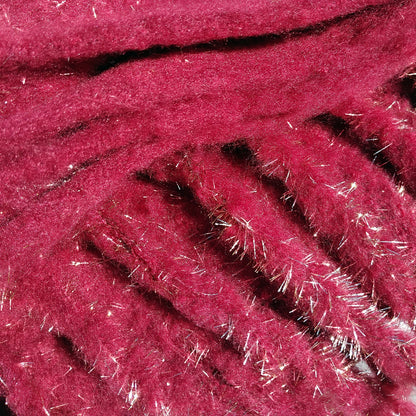 Close-up of a dark red scarf that is very soft and warm and has gold metallic fibres and  a chunky fringe
