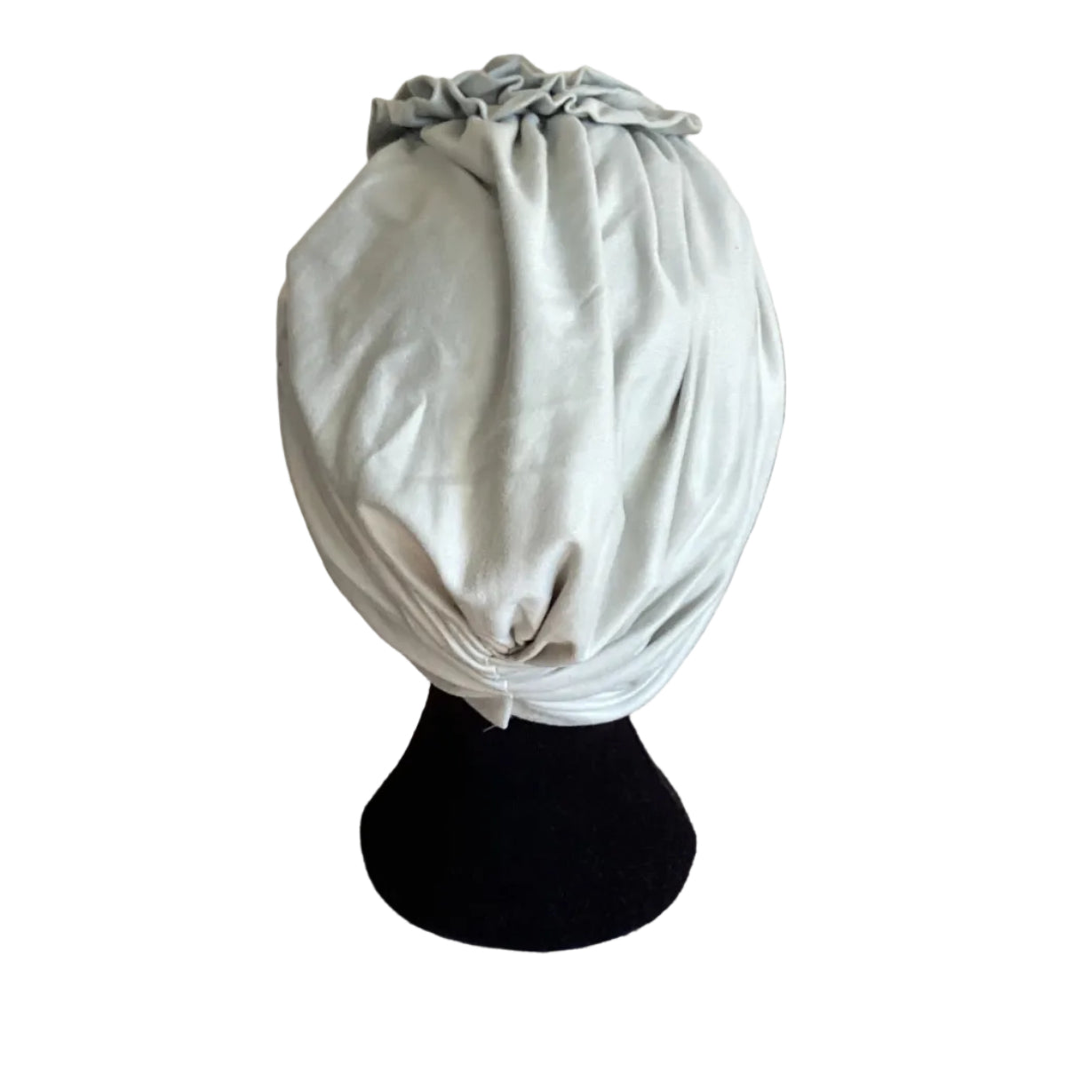 bakc view of a pale green hair turban on black head mannequin