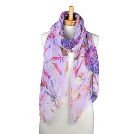 a pretty purple scarf that has large purple banksia flowers on a pale purple background.