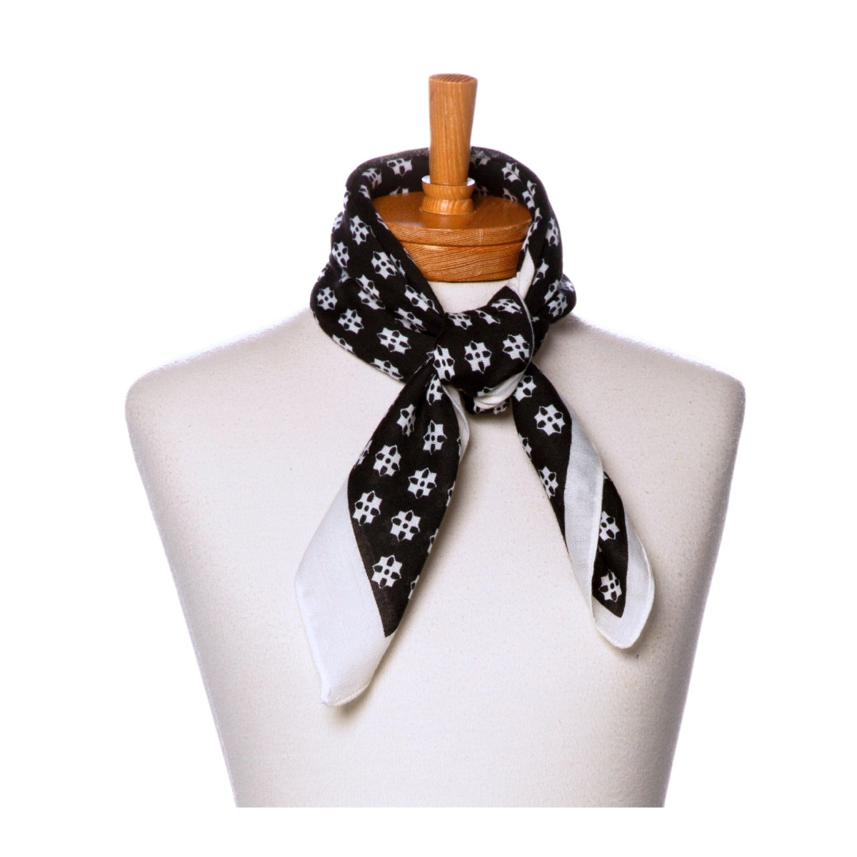 Black and white patterned scarf on a mannequin with a white background