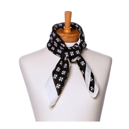 Black and white patterned scarf on a mannequin with a white background