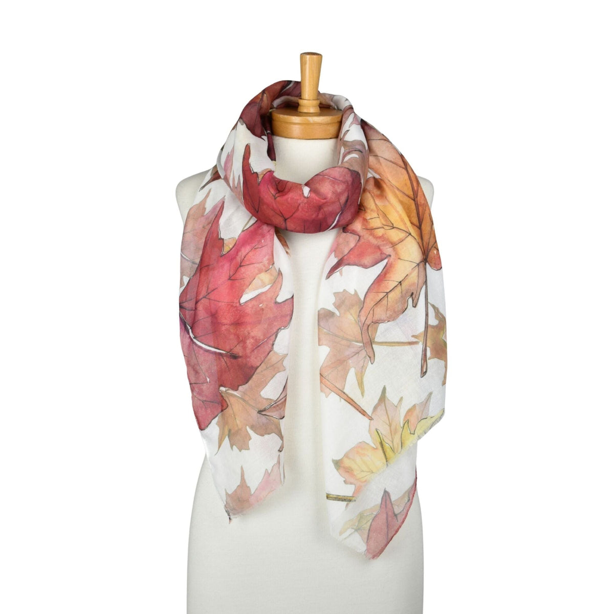Scarf with autumn leaf pattern on a mannequin against a white background