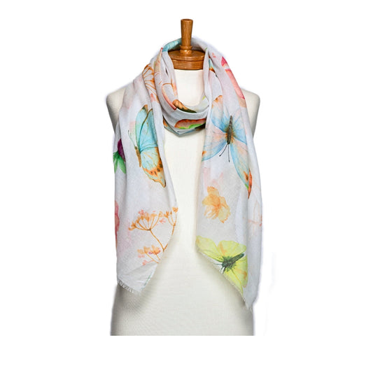 A butterfly and floral patterned scarf on a mannequin against a white background