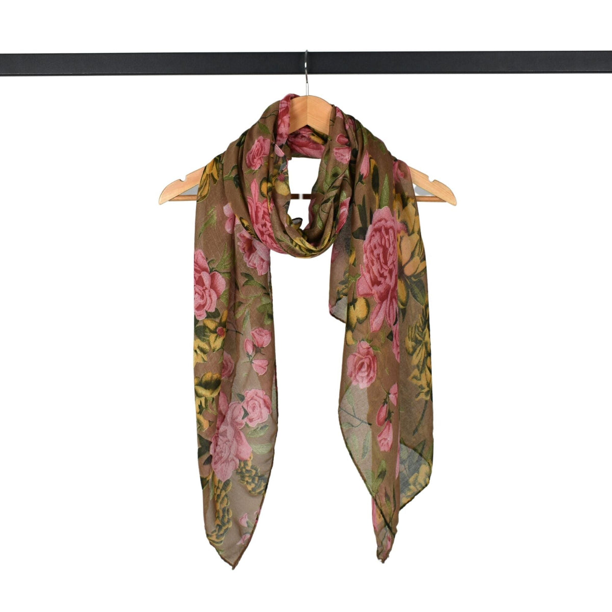 Floral patterned scarf on a wooden hanger against a white background