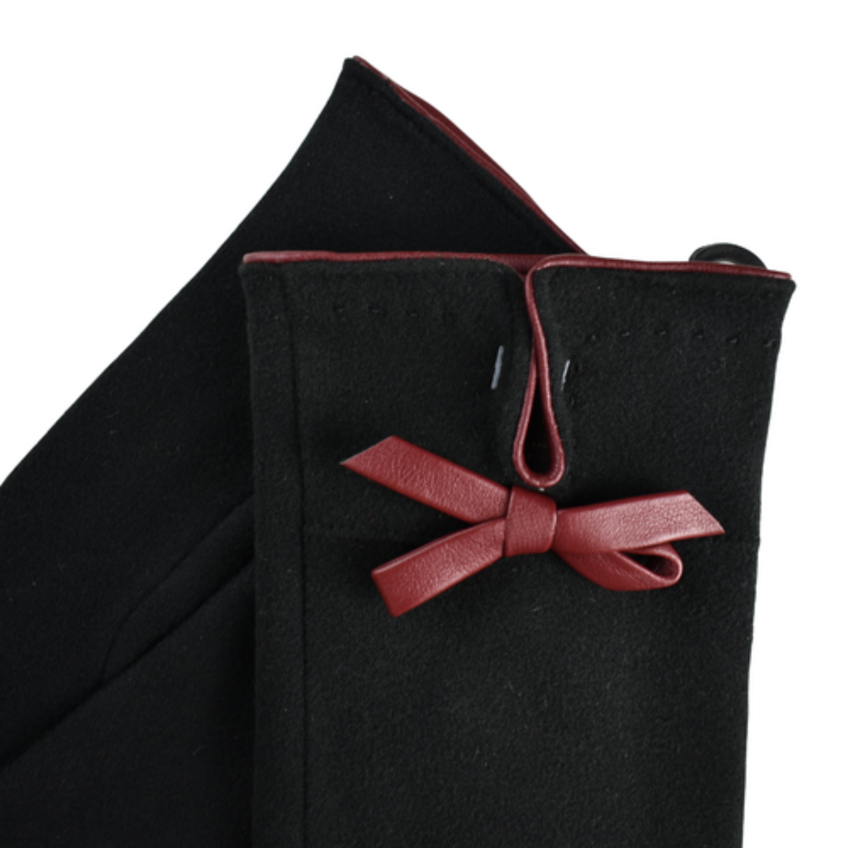 Black Ladies gloves with a red leatherette bow on a white background
