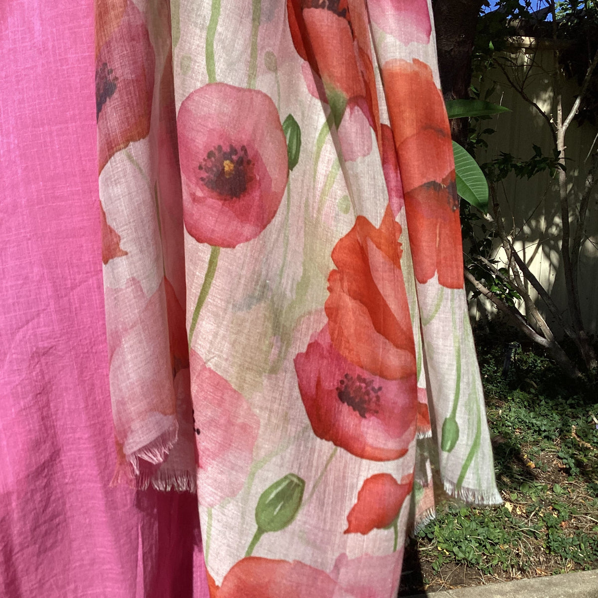 Floral-patterned fabric with red and pink flowers on a white background.